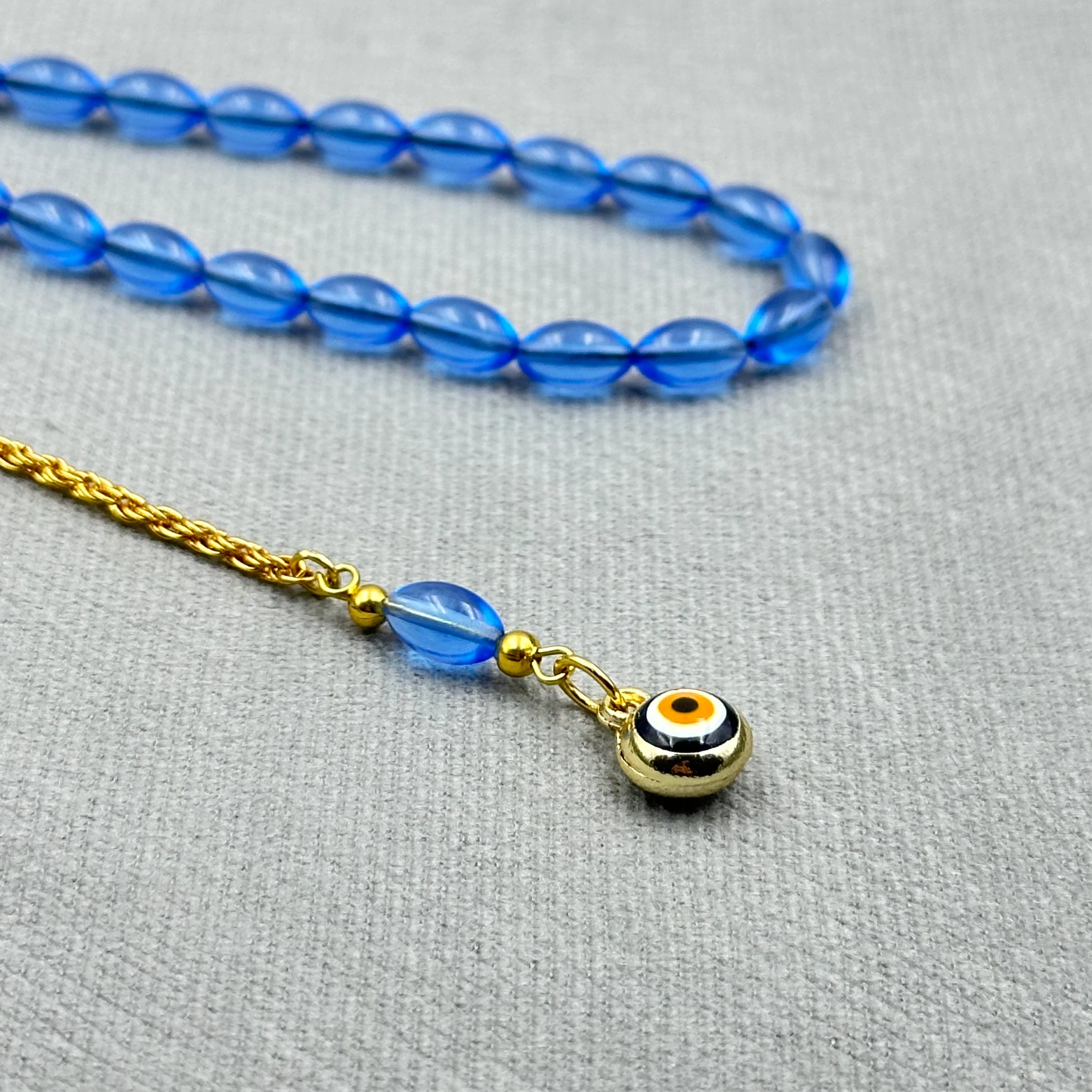 Pirinç Püsküllü Nazar Boncuğu Detaylı Bilek Boy Mavi Uçak Camı Tespih